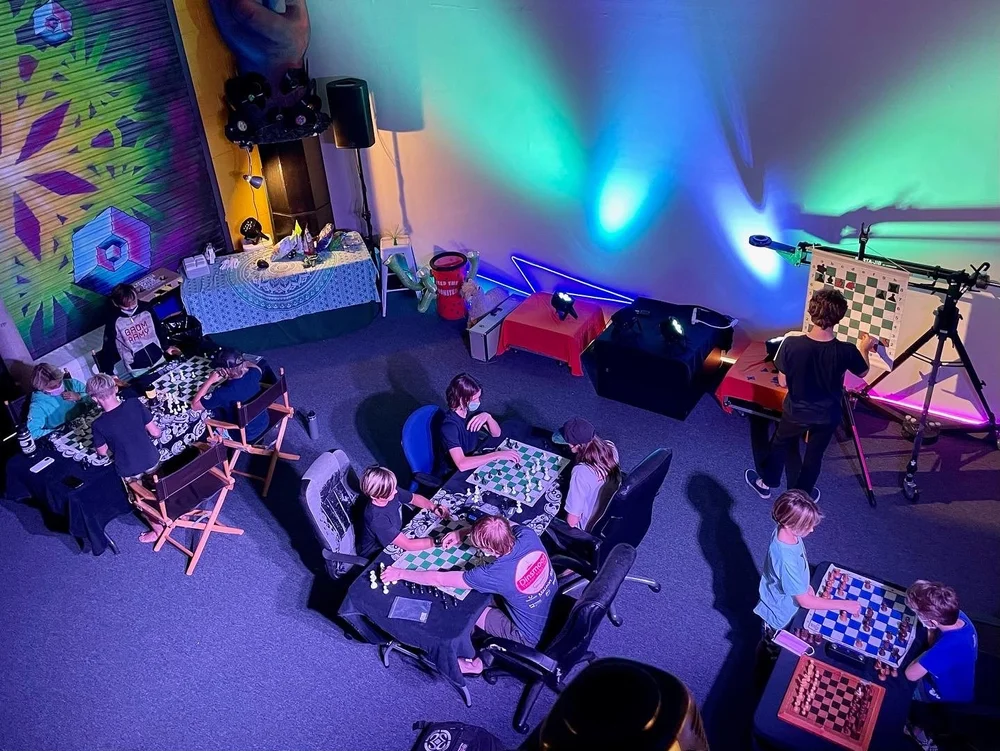 Kids playing chess at a club night